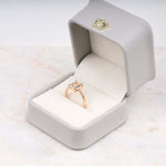 Load image into Gallery viewer, Radiant diamond ring worn on hand with peach-toned lighting
