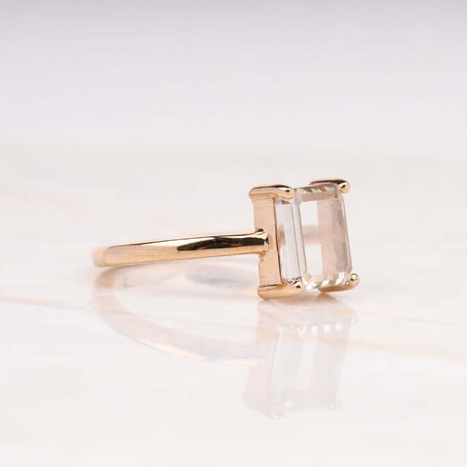 Radiant diamond ring shown from above on a white cloth