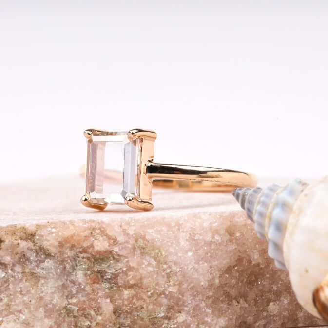Radiant diamond ring worn on a finger in natural lighting"