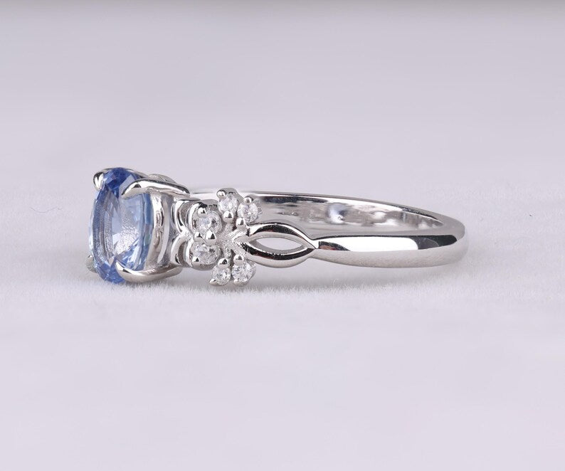 Blue Oval Gemstone Ring with Floral Diamond Accents