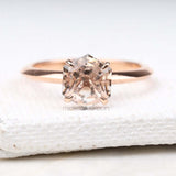 Diamond ring in four prong setting on light cushion – detailed close-up shot