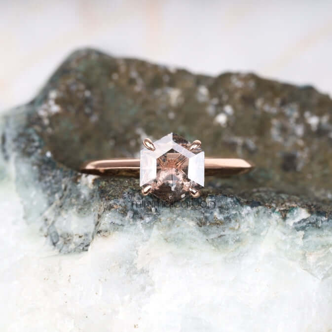 Four prong diamond ring showcased on a rustic background – moody and elegant shot