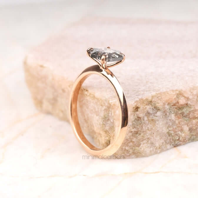 Side view of four prong set ring on neutral backdrop – highlighting the band design