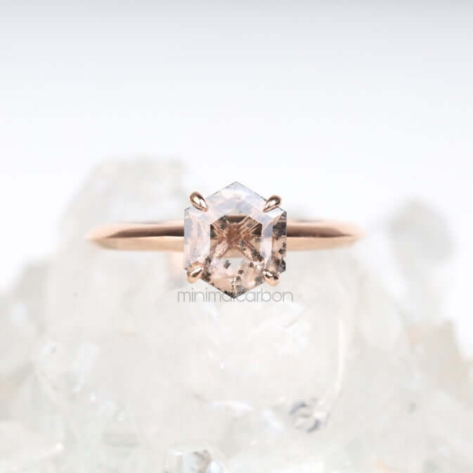Hand holding rose gold four prong ring – intimate bridal jewelry display
