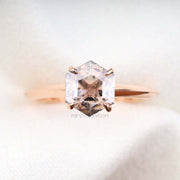 Elegant four prong engagement ring in rose gold with round cut diamond on white background