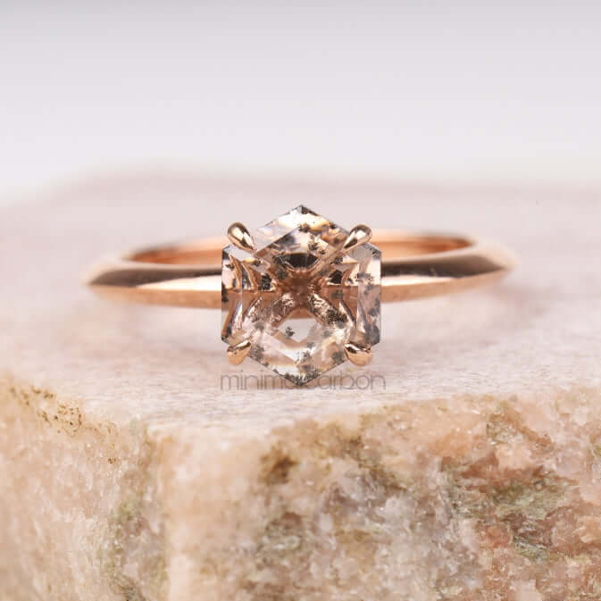 Engagement ring on natural stone – showcasing four prong setting and classic cut