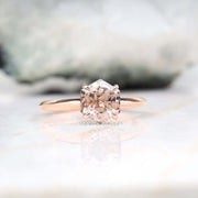 Close-up of four prong diamond ring on a display stand – minimalist and modern style
